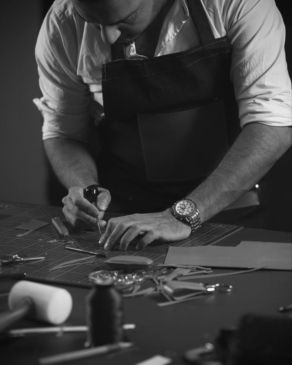 Leather and tools on a workshop bench