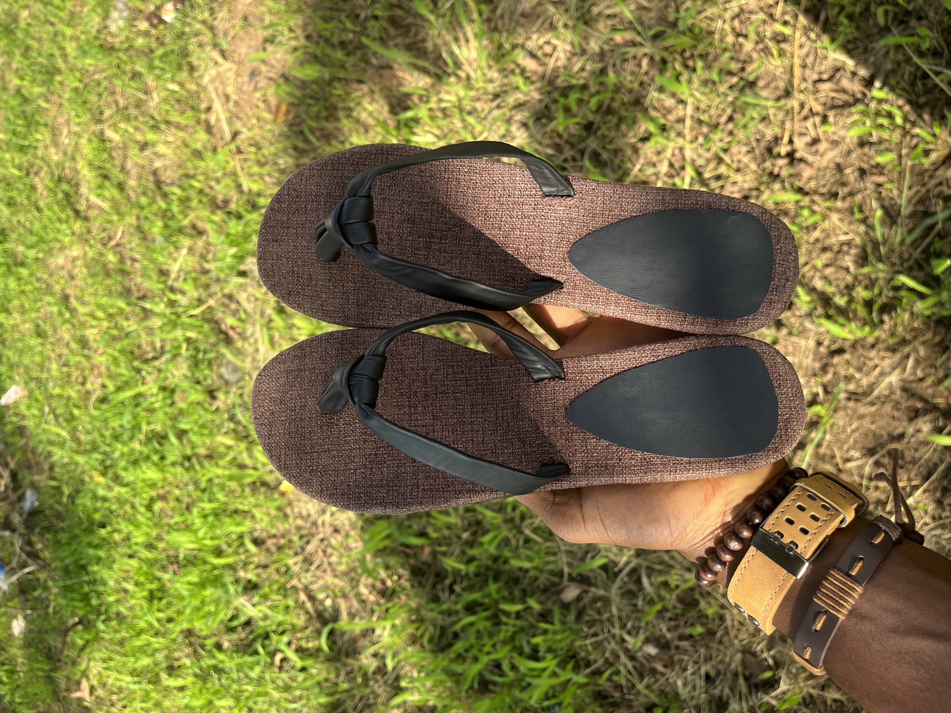 Handmade leather palm slippers in warm sunlight
